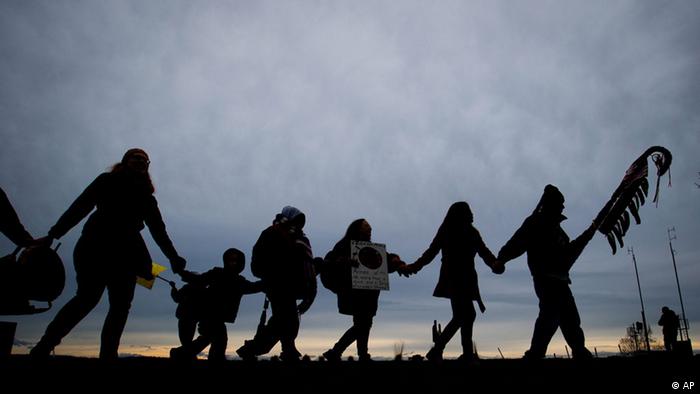 Idle No More protesters hold hands and dance (Photo: Darryl Dyck)
