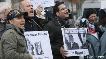 Protesters demonstrate near the Chancellery prior to the arrival of Egyptian President Mohammed Morsi at the Chancellery on January 30, 2013 in Berlin, Germany. Mursi has come to Berlin despite the ongoing violent protests in recent days in cities across Egypt that have left at least 50 people dead. Morsi is in Berlin to seek both political and financial support from Germany. (Photo by Sean Gallup/Getty Images) 