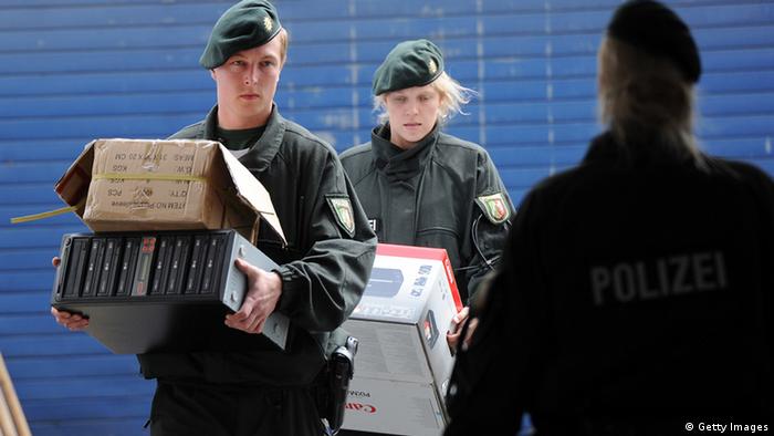 Policemen carry boxes and computers on June 14, 2012 during a raid at the Millatu Ibrahim Mosque in Solingen, western Germany. German police carried out raids in seven different regional states targeting individuals suspected of belonging to radical Islamic Salafist groups, the interior ministry said. At the same time, Interior Minister Hans-Peter Friedrich banned one particular network known as Millatu Ibrahim. AFP PHOTO / HENNING KAISER GERMANY OUT (Photo credit should read HENNING KAISER/AFP/GettyImages)
