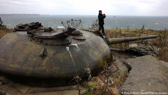 Russian President Dmitry Medvedev walks near a Soviet-era fortifications during his visit to one of the Kuril islands on November 1, 2010. Medvedev stoked Japan's ire on Monday with a visit to the Kuril islands, a remote territory at the heart of a decades-long dispute with Tokyo. AFP PHOTO/ RIA-NOVOSTI/ KREMLIN POOL/ MIKHAIL KLIMENTYEV (Photo credit should read MIKHAIL KLIMENTYEV/AFP/Getty Images) 
