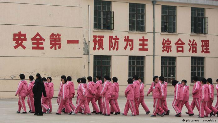 --FILE--A Chinese police officer escorts inmates at a female labor camp in Jurong city, east Chinas Jiangsu province, 6 March 2008. Meng Jianzhu, who became secretary of the Political and Legal Affairs Committee in November, said at a national law and order work conference that the re-education through labour, or laojiao, system would be halted after the move was rubber-stamped by the National Peoples Congress in March. The remarks were first reported by the bureau chief of the Legal Daily, the Justice Ministrys official mouthpiece, and were picked up by state media outlets. An official who attended the event confirmed Mengs comments. But state media sent mixed signals about the policy. A Xinhua report on the conference said only that authorities had pledged to reform the system, and some analysts noted that Meng spoke of halting rather than abolishing the laojiao system.
pixel