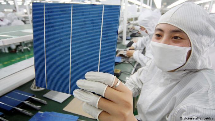 --FILE--Chinese workers manufacture photovoltaic cells of solar panels at the plant of Eoplly New Energy Technology Co., Ltd. in Nantong city, east Chinas Jiangsu province, 21 February 2011. The US on Wednesday (9 November 2011) opened an official investigation into whether imported Chinese solar cells were unfairly undercutting American products, the first such case in the renewable energy sector. The complaint alleges that solar cells from China are being dumped in the US, with normal prices between 50 per cent and 250 per cent higher than the export price. If the commerce department finds evidence of dumping or of unfair state subsidy, compensatory tariffs can be imposed on the Chinese imports. Photo: Xu Ruiping/Imaginechina  