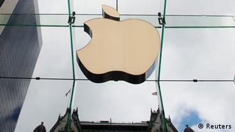The Apple logo hangs in a glass enclosure above the Fifth Avenue Apple Store in New York in this September 20, 2012 file photo. Apple Inc. is experimenting with the design of a device similar to a wristwatch that would operate on the same platform as the iPhone and would be made with curved glass, the New York Times reported on February 10, 2013. REUTERS/Lucas Jackson/Files (UNITED STATES - Tags: BUSINESS SCIENCE TECHNOLOGY LOGO TPX IMAGES OF THE DAY)