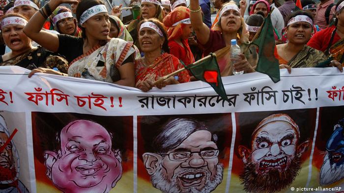 Bangladeshi women shout slogans demanding the execution of Jamaat-e-Islami leader Abdul Quader Mollah and others convicted of war crimes involving the nation's independence war in 1971, in Dhaka, Bangladesh, Wednesday, Feb. 13, 2013. Protestors urged Prime Minister Sheikh Hasina to review a verdict sentencing the senior leader of Bangladesh's largest Islamic party to life in prison for killings and other crimes. The protesters said the life term was not enough since a tribunal had found Abdul Quader Mollah guilty of five charges, including playing a role in the killing of 381 unarmed civilians. Banner reads we demand the execution of those convicted of war crimes. (AP Photo/Pavel Rahman)  