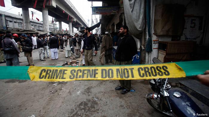 Police investigators cordon off a site of a bomb attack in a market selling mobile phones at Hashtnagri bazaar in Peshawar February 21, 2013. (Photo: REUTERS/Fayaz Aziz)