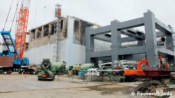 The No.4 reactor (L) and a foundation structure for the construction of a storage facility for melted fuel rods are seen at Tokyo Electric Power Co (TEPCO)'s tsunami-crippled Fukushima Daiichi nuclear power plant in Fukushima prefecture, in this photo released by Kyodo March 1, 2013, ahead of the second-year anniversary of the March 11, 2011 earthquake and tsunami. Mandatory Credit REUTERS/Kyodo (JAPAN - Tags: DISASTER ANNIVERSARY BUSINESS SCIENCE TECHNOLOGY CONSTRUCTION) ATTENTION EDITORS -THIS IMAGE HAS BEEN SUPPLIED BY A THIRD PARTY. IT IS DISTRIBUTED, EXACTLY AS RECEIVED BY REUTERS, AS A SERVICE TO CLIENTS. FOR EDITORIAL USE ONLY. NOT FOR SALE FOR MARKETING OR ADVERTISING CAMPAIGNS. MANDATORY CREDIT. JAPAN OUT. NO COMMERCIAL OR EDITORIAL SALES IN JAPAN. YES