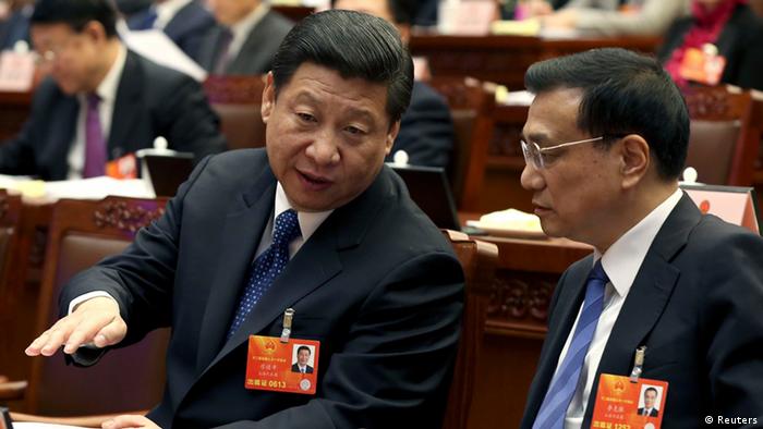 China's Communist Party Chief Xi Jinping talks to China's Vice Premier Li Keqiang during the presidium of the first session of the 12th National People's Congress (NPC) in Beijing, March 4, 2013. Deputies of the 12th NPC elected the presidium on Monday morning and set up agenda for the legislative session which begins on Tuesday. REUTERS/China Daily (CHINA - Tags: POLITICS) CHINA OUT. NO COMMERCIAL OR EDITORIAL SALES IN CHINA