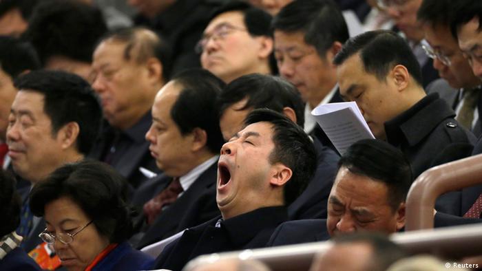 A delegate yawns during the opening ceremony of National People's Congress (NPC) at the Great Hall of the People in Beijing, March 5, 2013. REUTERS/Jason Lee (CHINA - Tags: POLITICS)