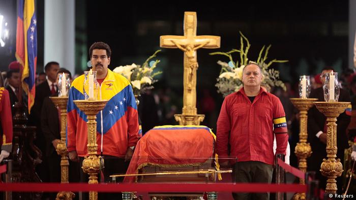 Venezuela's Vice President Nicolas Maduro, left, and National Assembly President Diosdado Cabello stand guard next to the coffin of late Venezuelan President Hugo Chavez