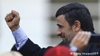 Iran's President Mahmoud Ahmadinejad raises his clenched fist in salutation during the funeral of Venezuela's President Hugo Chavez in Caracas, on March 8, 2013. Latin American leaders and US foes paid tribute to Venezuelan leader Hugo Chavez on Friday as he lay in state in a flag-draped coffin during a lavish state funeral before the nation swears-in an interim president. AFP PHOTO/JUAN BARRETO (Photo credit should read JUAN BARRETO/AFP/Getty Images) 