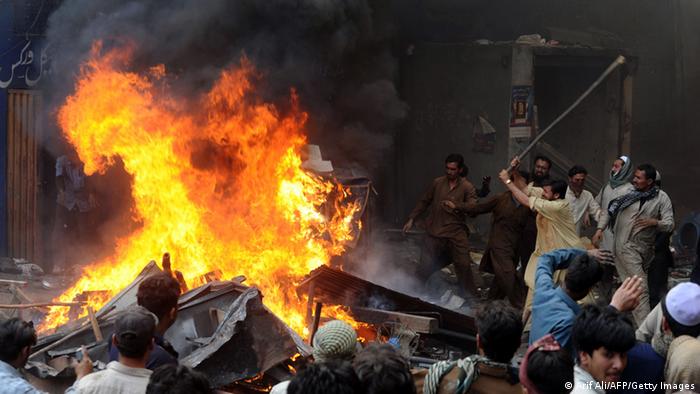 Angry Pakistani demonstraters torch Christian's belongings during a protest over a blasphemy row in a Christian neighborhood in Badami Bagh area of Lahore on March 9, 2013
(Photo: Arif Ali/AFP/Getty Images)