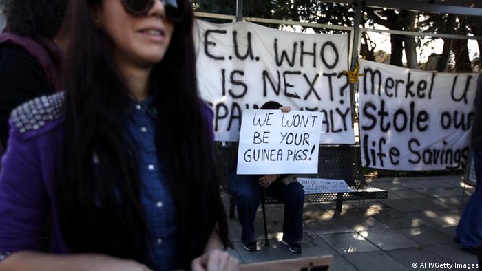 Cypriots hold placards during a protest against an EU bailout deal outside the parliament in Nicosia on March 18, 2013. 
Photo: PATRICK BAZ/AFP/Getty Images