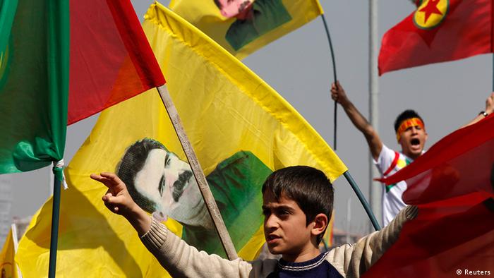 Demonstrators hold Kurdish flags and flags with portraits of jailed Kurdistan Workers Party (PKK) leader Abdullah Ocalan during a gathering to celebrate Newroz in the southeastern Turkish city of Diyarbakir March 21, 2013. Ocalan ordered his fighters on Thursday to cease fire and withdraw from Turkish soil as a step to ending a conflict that has killed 40,000 people, riven the country and battered its economy. Hundreds of thousands of Kurds, gathered in the regional centre of Diyarbakir, cheered and waved banners bearing Ocalan's moustachioed image when a letter from the rebel leader, held since 1999 on a prison island in the Marmara Sea, was read out by a pro-Kurdish politician. REUTERS/Umit Bektas (TURKEY - Tags: POLITICS CIVIL UNREST)
ags: POLITICS CIVIL UNREST TPX IMAGES OF THE DAY)