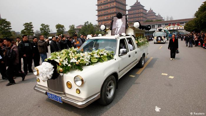 A vehicle carries the coffin of Wu Renbao, the former party secretary of Huaxi village, also known as China's richest village, during his funeral in Huaxi, Jiangsu province, March 22, 2013. Huaxi, a booming market town, is a capitalist success story despite decades of Communist control. A sleepy farming village of about 600 people in the 1950s, it survived the chaotic years of the Cultural Revolution and blossomed during China's subsequent economic transformation. Today it is a poster child for economic success. Residents credit the pragmatic polices and astute leadership of Wu Renbao for their success. Wu, who had mostly retired from political life, acted as an ambassador for the village as well as a living tourist attraction for those seeking to find out how he transformed Huaxi. REUTERS/Aly Song (CHINA - Tags: POLITICS BUSINESS SOCIETY)