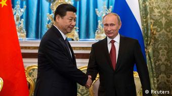 Russia's President Vladimir Putin (R) shakes hands with his Chinese counterpart Xi Jinping during a meeting at the Kremlin in Moscow March 22, 2013. 