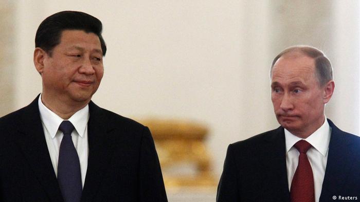 Chinese President Xi Jinping (L) looks at his Russian counterpart Vladimir Putin during their meeting at the Kremlin in Moscow March 22, 2013. REUTERS/Sergei Karpukhin (RUSSIA - Tags: POLITICS)