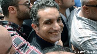 Egyptian satirist and television host Bassem Youssef surrounded by supporters upon arrival to prosecutor's office