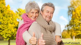 Elderly couple giving the thumbs-up sign