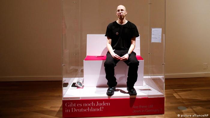 In this March 22, 2013 file photo, Israeli Ido Porat prepares to be the first person acting as the 'Jew in a glass box', on the first day of the exhibition The Whole Truth, everything you always wanted to know about Jews at the Jewish Museum in Berlin. (AP Photo/Markus Schreiber, File) 