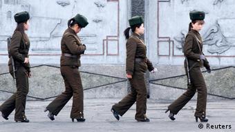 Female North Korean soldiers patrol along the banks of Yalu River, near the North Korean town of Sinuiju, opposite the Chinese border city of Dandong, April 11, 2013. South Korea and the United States were on high alert for a North Korean missile launch on Thursday as the hermit kingdom turned its attention to celebrating its ruling Kim dynasty and appeared to tone down rhetoric of impending war. REUTERS/Jacky Chen (NORTH KOREA - Tags: POLITICS MILITARY ANNIVERSARY TPX IMAGES OF THE DAY)
