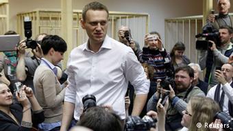 Navalny looks on surrounded by journalists after arriving for his court hearing
REUTERS/Maxim Shemetov 