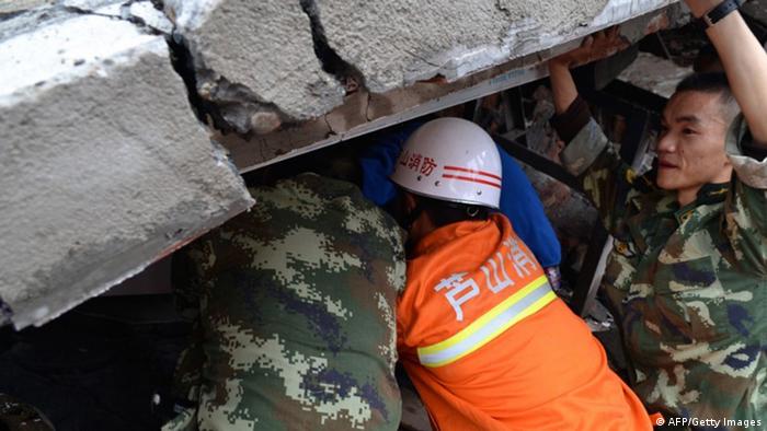 Rescuers work to rescue a child from her collapsed home after an earthquake hit Ya'an City in Lushan county, southwest China's Sichuan province on Saturday. (Photo: STR/AFP/Getty Images) 
