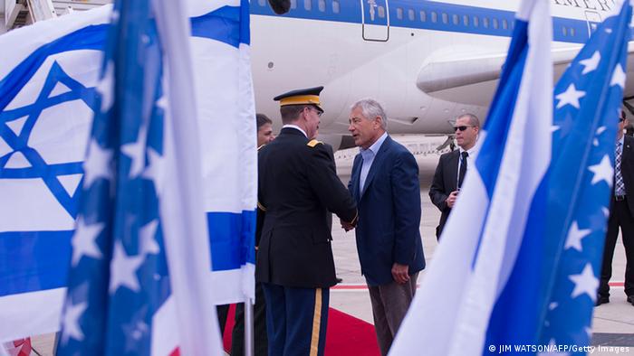 US Secretary of Defense Chuck Hagel (R) shakes hands with dignitaries as he arrives in Tel Aviv, Israel on April 21, 2013. Asked if a multi-billion dollar arms package with Israel was designed to convey a message that a military strike remains an option, Hagel said before landing in Tel Aviv: I don't think there's any question that's another very clear signal to Iran. AFP PHOTO/POOL/JIM WATSON (Photo credit should read JIM WATSON/AFP/Getty Images)