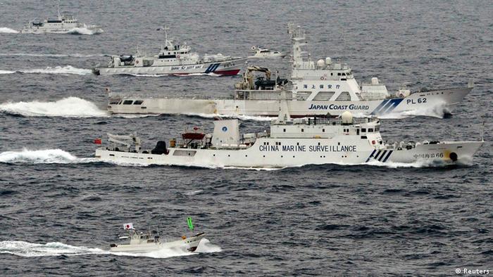 An aerial photo shows a Chinese marine surveillance ship Haijian No. 66 (C) cruising next to Japan Coast Guard patrol ships in the East China Sea, near known as Senkaku isles in Japan and Diaoyu islands in China, in this photo taken by Kyodo April 23, 2013. Japanese nationalists sailed a flotilla of boats on Tuesday in waters near islands at the centre of a row between China and Japan, putting further strain on Tokyo's tense ties with Beijing as a group of more than 160 Japanese lawmakers visited a shrine seen by critics a symbol of Japan's past militarism. Japanese and Chinese patrol ships have been playing a cat-and-mouse game near the Japanese-controlled East China Sea islands, where China is seeking to assert its claim to sovereignty by sending ships into the disputed waters. Mandatory Credit. REUTERS/Kyodo (JAPAN - Tags: POLITICS) FOR EDITORIAL USE ONLY. NOT FOR SALE FOR MARKETING OR ADVERTISING CAMPAIGNS. THIS IMAGE HAS BEEN SUPPLIED BY A THIRD PARTY. IT IS DISTRIBUTED, EXACTLY AS RECEIVED BY REUTERS, AS A SERVICE TO CLIENTS. MANDATORY CREDIT. JAPAN OUT. NO COMMERCIAL OR EDITORIAL SALES IN JAPAN. YES