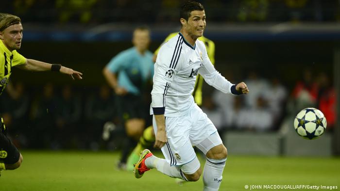 Real Madrid's Portuguese forward Cristiano Ronaldo (R) runs with the ball during the UEFA Champions League semi final first leg football match between Borussia Dortmund and Real Madrid on April 24, 2013 in Dortmund, western Germany. AFP PHOTO / JOHN MACDOUGALL (Photo credit should read JOHN MACDOUGALL/AFP/Getty Images)