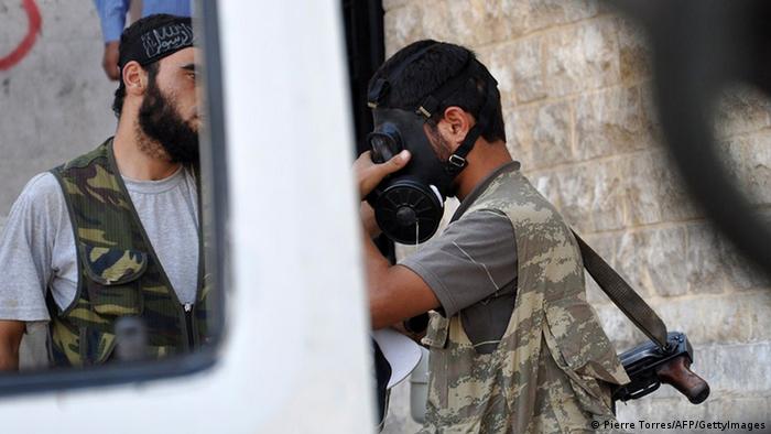 A Syrian opposition fighter tries a gasmask in the northern city of Aleppo on July 25, 2012. (Photo: Pierre Torres/AFP/GettyImages)