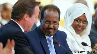 LONDON, UNITED KINGDOM - MAY 7: Prime Minister David Cameron (L) and Somali President Hassan Sheikh Mohamud (C) shake hands after making their opening speeches during the Somali conference, on May 7, 2013 in London, England. The international conference aims to help rebuild the east African country after more more than two decades of conflict. (Photo by Andrew Winning - WPA Pool/Getty Images) 