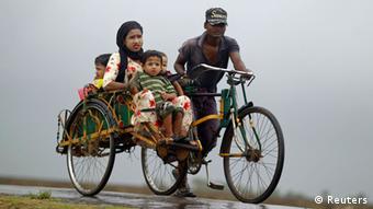 A family travels on a trishaw to a safe place from Cyclone Mahasen at a Rohingya internally displaced persons (IDP) camp outside of Sittwe, May 16, 2013. (Photo: Reuters)