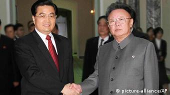 In this photo released by China's Xinhua News Agency, North Korean leader Kim Jong Il, right, shakes hands with Chinese President Hu Jintao before their talks in Pyongyang, Friday,Oct. 28, 2005. North Korean leader Kim promised Friday to take part in the next round of nuclear talks scheduled for November, Chinese state television reported, as China's president made a rare personal visit to Pyongyang to lobby for progress in disarmament efforts. Kim reportedly told President Hu Jintao that the North was committed to a nuclear-free Korean peninsula. It was the highest-level commitment yet by the Stalinist dictatorship to push ahead with talks aimed at stripping North Korea of its nuclear programs.(AP Photo/Xinhua, Yao Dawei)