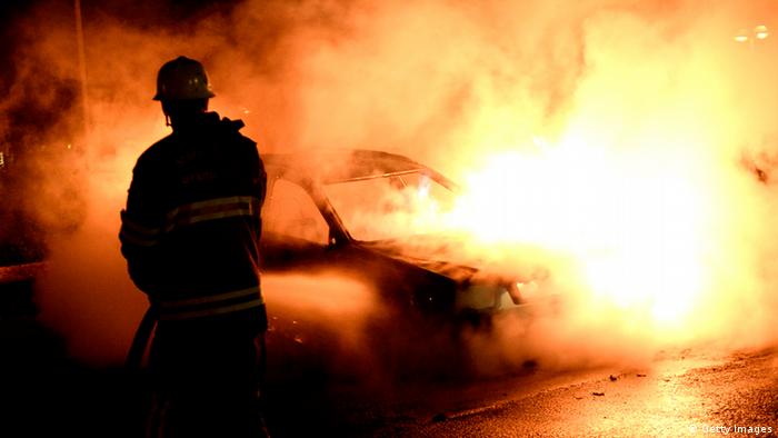 Firemen extinguish a burning car in Kista after youths rioted in suburbs in the greater Stockholm area on May 21, 2013. Youths in the immigrant-heavy Stockholm suburb of Husby torched cars and threw rocks at police, in riots believed to be linked to the deadly police shooting of a local resident. Photo: JONATHAN NACKSTRAND/AFP/Getty Images
