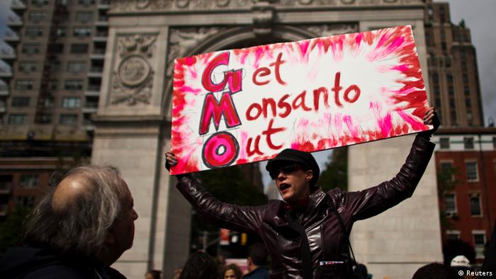A woman holds up a poster during a protest against U.S.-based Monsanto REUTERS/Eduardo Munoz 