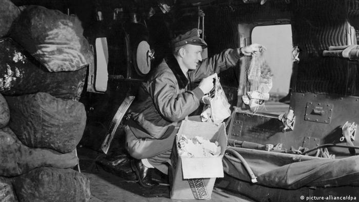 Gail Halvorsen, pictured here in 1948, shows how he delivered the candy 'bombs' during the Berlin Airlift