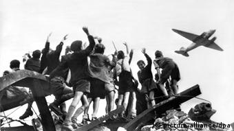 Boys in West Berlin celebrate the arrival of the candy bombers