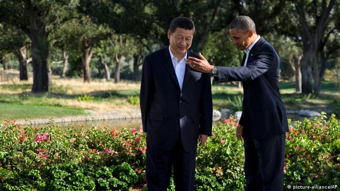 President Barack Obama gestures with Chinese President Xi Jinping at the Annenberg Retreat at Sunnylands as they meet for talks Friday, June 7, 2013, in Rancho Mirage, Calif. Seeking a fresh start to a complex relationship, the two leaders are retreating to the sprawling desert estate for two days of talks on high-stakes issues, including cybersecurity and North Korea's nuclear threats. (AP Photo/Evan Vucci) 