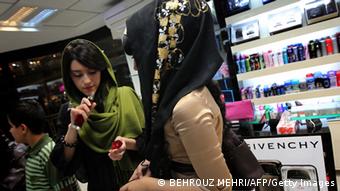 TO GO WITH AFP STORY BY SIAVOSH GHAZI Iranian women test the fragrances of perfumes at a store in Tehran on May 13, 2010. Iran is the second largest consumer of cosmetics in the Middle East despite being ruled by Islamists who have sought for three decades to keep women modestly dressed and penalise glossy lips outside the house. AFP PHOTO/BEHROUZ MEHRI (Photo credit should read BEHROUZ MEHRI/AFP/Getty Images)