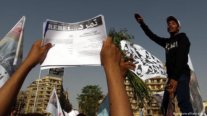 Egyptian protesters hold applications for 'Tamarod', for a campaign calling for the ouster of Egyptian President Mohammed Morsi and for early presidential elections, during a protest in Tahrir Square, in Cairo, Egypt, 17 May 2013. Hundreds of demonstrators called for the removal of President Morsi, the Muslim Brotherhood and early elections. EPA/KHALED ELFIQI