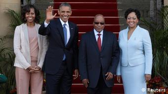 U.S. President Barack Obama (2nd L) waves next to First Lady Michelle Obama (L), South Africa's President Jacob Zuma (2nd R) and his wife, First Lady Thobeka Madiba-Zuma, at the Union Building in Pretoria, June 29, 2013. Obama paid tribute to anti-apartheid hero Nelson Mandela as he flew to South Africa on Friday but played down expectations of a meeting with the ailing black leader during an Africa tour promoting democracy and food security. REUTERS/Gary Cameron (SOUTH AFRICA - Tags: POLITICS)
