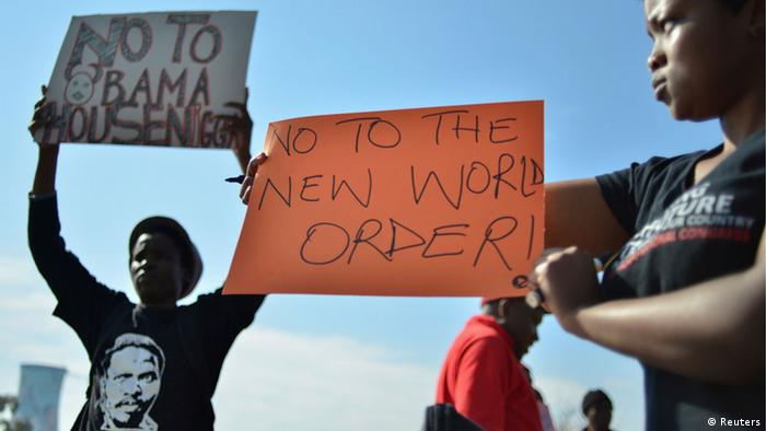 Protesters hold placards outside the University of Johannesburg in Soweto, ahead of a visit by U.S. President Barack Obama, June 29, 2013. REUTERS/Mujahid Safodien (SOUTH AFRICA - Tags: POLITICS CIVIL UNREST EDUCATION)
