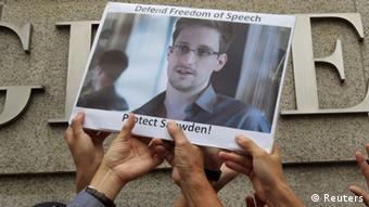 People holding up poster of Edward Snowden
REUTERS/Bobby Yip/Files 
