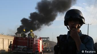 Afghan security forces keep watch as smoke rises from the site of an attack in Kabul, July 2, 2013.(Photo: Reuters)