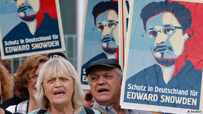 Demonstrators hold banner during protest rally in support of former U.S. spy agency NSA contractor Edward Snowden in Berlin July 4, 2013. The sentence reads: Shelter in Germany for Edward Snowden. (Photo: REUTERS/Tobias Schwarz)
