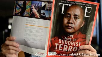 This illustration picture taken on June 24, 2013 in Bangkok shows a man reading a copy of the July 1 issue of Time magazine carrying a picture of controversial Myanmar monk Wirathu on its cover. (Photo: AFP)