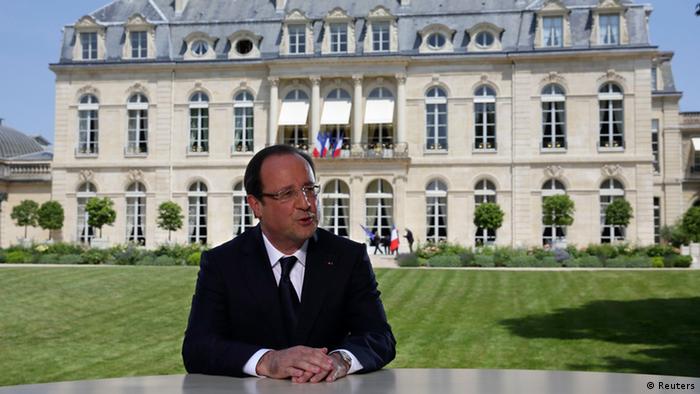 French President Francois Hollande speaks with journalists after a television interview in the garden of the Elysee Palace following the traditional Bastille day military parade in Paris (Photo: REUTERS/Philippe Wojazer)