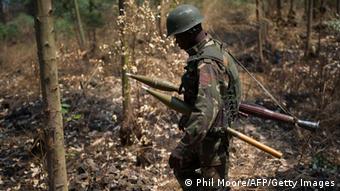 A Congolese army soldier walks through the bush, back from an attack position north-west of Munigi, overlooking the front-line, in the east of the Democratic Republic of the Congo on July 15, 2013. Fighting broke out yesterday between M23 rebels and the national army, and continued today, with heavy artillery fire north-west of Munigi and the army claiming to have taken ground. AFP PHOTO/PHIL MOORE (Photo credit should read PHIL MOORE/AFP/Getty Images) 