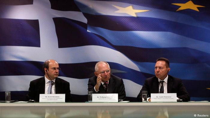 German Finance Minister Wolfgang Schaeuble flanked by his Greek counterpart Yannis Stournaras (R) and Greece's Minister for Development & Competitiveness Kostis Hatzidakis
Photo: REUTERS/John Kolesidis