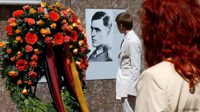 Visitors walk past a portrait of Claus Schenk Graf von Stauffenberg, who conspired to overthrow Adolf Hitler 
(Photo: REUTERS/Tobias Schwarz)